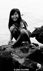 This young Indonesian girl was busy catching small fish, ... by Paul Duxfield 